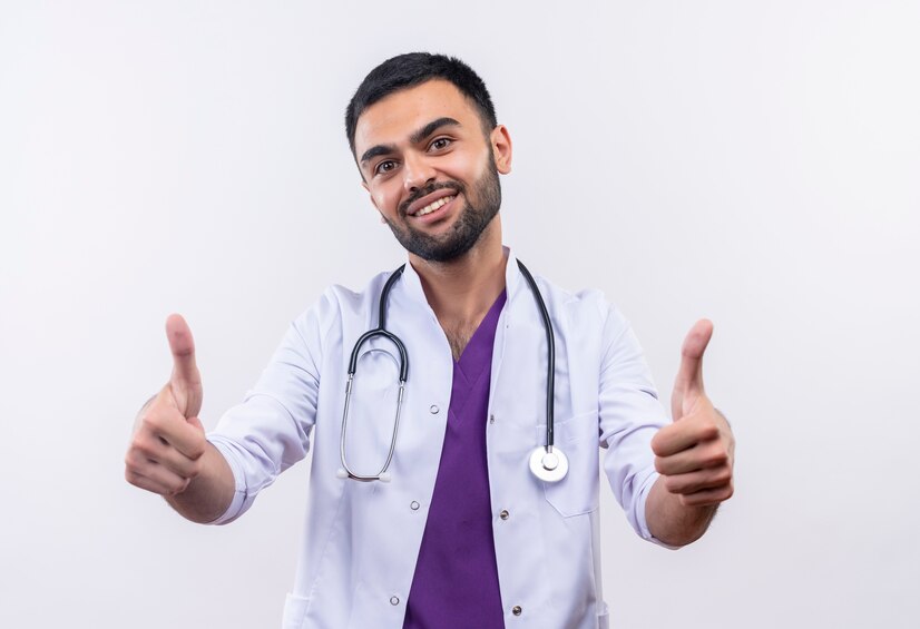 smiling young male doctor wearing stethoscope medical gown his thumbs up isolated white background_141793 38958